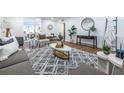 Bright living room featuring contemporary decor, hardwood floors, and an eye-catching patterned rug at 115 Biscayne Nw Dr # F10, Atlanta, GA 30309