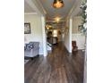 Inviting foyer with wood flooring, a staircase, and views into the open living spaces at 2159 Holland Creek Ln, Buford, GA 30519