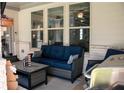 Inviting covered patio with outdoor seating, grill, and a view of the home's architecture at 2159 Holland Creek Ln, Buford, GA 30519