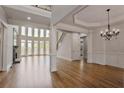 Bright open-concept living area with hardwood floors, large windows, and a stone fireplace at 3487 Binghurst Rd, Suwanee, GA 30024