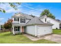 Charming two-story home with a two-car garage and manicured lawn at 161 Brasch Park Dr, Grantville, GA 30220
