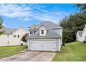 Two story home with two car garage and driveway surrounded by lawn at 161 Brasch Park Dr, Grantville, GA 30220