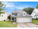 Charming two-story home with a two-car garage and manicured lawn at 161 Brasch Park Dr, Grantville, GA 30220