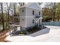Stylish two-story home with a multilevel deck, complemented by a spacious driveway and landscaping at 2125 Clay Rd, Austell, GA 30106