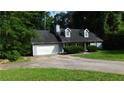 Classic single-story home with blue siding, dormer windows, a 2-car garage, and a lush green lawn at 330 Christian Woods Dr, Conyers, GA 30013