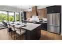Modern kitchen featuring an island with seating, stainless steel appliances, and backyard views at 1063 Winding Branch Dr, Canton, GA 30114
