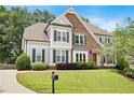 Beautiful home showcasing a lush green lawn and a welcoming brick and siding exterior at 113 Stargaze Rdg, Canton, GA 30114