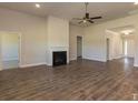 Spacious living room with hardwood floors, fireplace, ceiling fan, and ample natural light at 251 Eason St, Bowdon, GA 30108