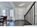 The foyer features a dark wood floor and staircase at 4825 Odum View Ln, Cumming, GA 30040