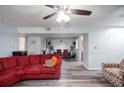 Spacious living room with ceiling fan opens to the dining room and kitchen at 6487 Northridge Way, Morrow, GA 30260