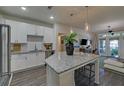 Modern kitchen featuring white cabinets, granite counters, stainless steel appliances, and island with seating at 840 United Ave # 113, Atlanta, GA 30312