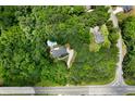 Aerial view showcases a private property with a pool, nestled within a lush green landscape at 1460 Bakers Bridge Rd, Douglasville, GA 30134