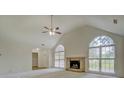 Bright living room boasts a fireplace, vaulted ceilings, and large arched windows at 2690 Ross Rd, Snellville, GA 30039