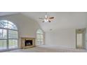 Bright living room with vaulted ceiling, fireplace, and large arched windows, filling the space with natural light at 2690 Ross Rd, Snellville, GA 30039