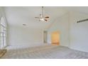 Bright, open living room features a vaulted ceiling, ceiling fan, and large windows at 2690 Ross Rd, Snellville, GA 30039