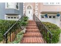 Charming brick staircase leading to the front door, complemented by manicured greenery and potted plants at 3745 Meeting St, Duluth, GA 30096