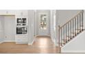 Inviting entryway with light wood floors, staircase, and built-in oven at 109 Laurelwood Ln, Dallas, GA 30157