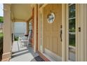 Inviting front door with sidelights and a welcoming wreath, complemented by a cozy porch at 1680 Laleiah Dr, Cumming, GA 30041