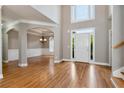 Open-concept foyer with hardwood floors, elegant lighting, and neutral paint at 3885 Lake Juliette Dr, Buford, GA 30519