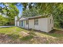 An eye-level view of a white brick house, surrounded by trees and lush greenery at 4345 Sasanqua Ct, Tucker, GA 30084