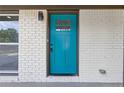 Close up showcasing the property's entrance featuring a blue door and white brick surround at 4345 Sasanqua Ct, Tucker, GA 30084