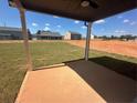 View from the covered patio showcasing white support pillars and neighborhood at 57 Longhorn Way, Auburn, GA 30011