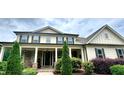Charming two-story home with stone accents, large windows, and a covered front porch perfect for relaxing at 140 Discovery Lake Dr, Fayetteville, GA 30215