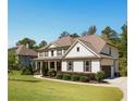 Charming home on a lush green lawn; features a side-entry garage and manicured landscaping at 140 Discovery Lake Dr, Fayetteville, GA 30215