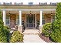 Inviting front porch with stone accents, overhead lighting, and well-maintained landscaping at 140 Discovery Lake Dr, Fayetteville, GA 30215