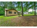 Charming home with brick and vinyl siding, surrounded by mature trees at 165 Wellington Dr, Mcdonough, GA 30252