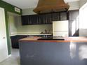 Functional kitchen with ample cabinet space and a central island cooktop at 3083 Colonial Way # E, Atlanta, GA 30341