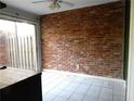 Bright sun room with brick accent wall and sliding glass door to the exterior at 3083 Colonial Way # E, Atlanta, GA 30341