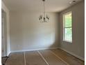 Bright dining area featuring a modern chandelier and large window with natural light at 344 Riverwood Pass, Dallas, GA 30157