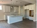 Bright kitchen featuring white cabinets, an island, and stainless steel appliances at 344 Riverwood Pass, Dallas, GA 30157