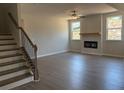 Spacious living room with a fireplace, ceiling fan, and hardwood flooring at 344 Riverwood Pass, Dallas, GA 30157