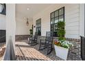 Inviting front porch with rocking chairs, brick floor, and stylish planters at 4020 Connolly Ct, Roswell, GA 30075