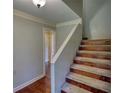 Carpeted and wood stairs in a home with light-colored walls and white trim at 1177 Castle Way Way, Norcross, GA 30093