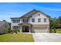 Charming two-story home with a brick-accented facade and well-manicured front lawn at 3005 Nicholas Dr, Villa Rica, GA 30180