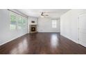 Spacious living room featuring hardwood floors, a stone fireplace, and bright natural light at 3005 Nicholas Dr, Villa Rica, GA 30180