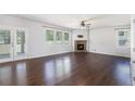 Spacious living room featuring hardwood floors, a stone fireplace, and access to the backyard at 3005 Nicholas Dr, Villa Rica, GA 30180