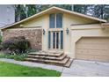 Charming single Gathering home with stone accents, well-manicured lawn and two-car garage at 3272 Pinestream Nw Rd, Atlanta, GA 30327