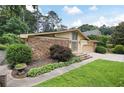Charming single Gathering home with stone accents, well-manicured lawn and two-car garage at 3272 Pinestream Nw Rd, Atlanta, GA 30327