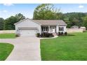The exterior of the home featuring a well-kept lawn and inviting curb appeal at 521 Peeples Valley Nw Rd, Cartersville, GA 30121
