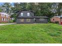 Well-kept home with a lush green lawn and a classic brick exterior at 1239 Teakwood Trl, Stone Mountain, GA 30083