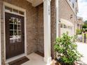 Welcoming front door with sidelights, brick facade, and the house number prominently displayed at 203 Holden Way, Woodstock, GA 30189