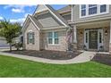 Charming two-story home featuring a brick and shingle facade with a covered porch and well-manicured lawn at 2118 Harmony Dr, Canton, GA 30115
