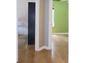 Bright bedroom showcasing hardwood floors, a closet, and neutral wall colors at 4517 Baker Grove Nw Rd, Acworth, GA 30101