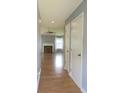 Bright hallway with hardwood floors leading to a living room with a fireplace at 4517 Baker Grove Nw Rd, Acworth, GA 30101