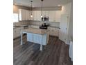 Spacious kitchen with white cabinets, granite counters, stainless appliances, and island at 596 Rodeo Dr, Auburn, GA 30011