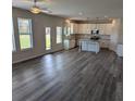 Open concept kitchen featuring stainless steel appliances, white cabinets, and island at 596 Rodeo Dr, Auburn, GA 30011